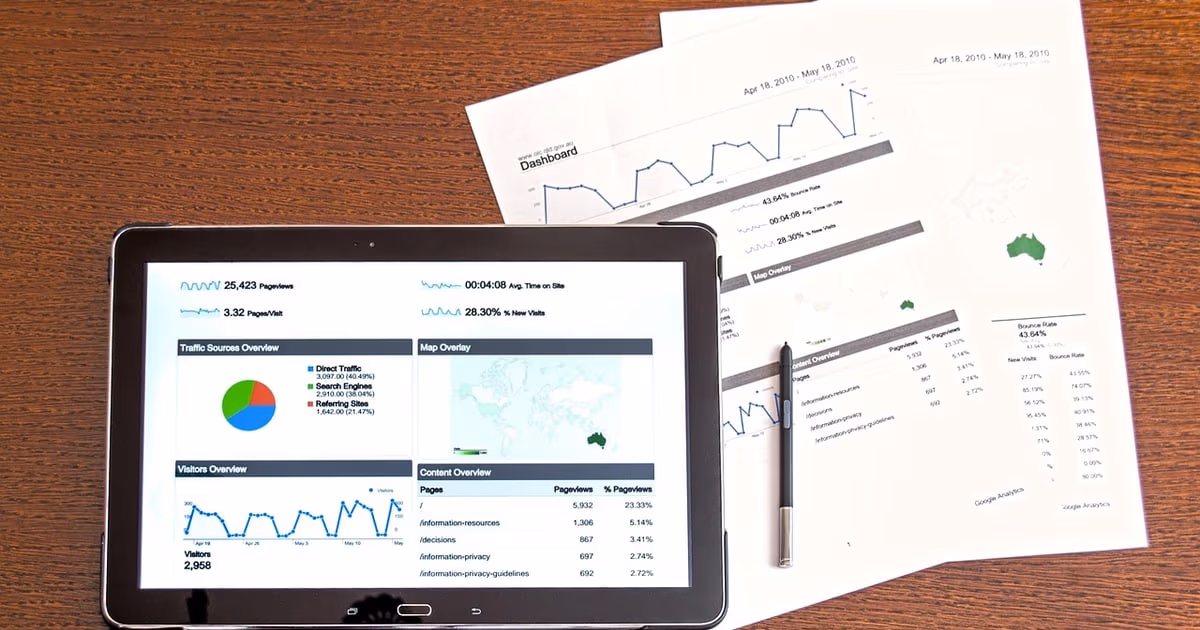 Laptop and notebook on a desk representing all-in-one business management software in 2026